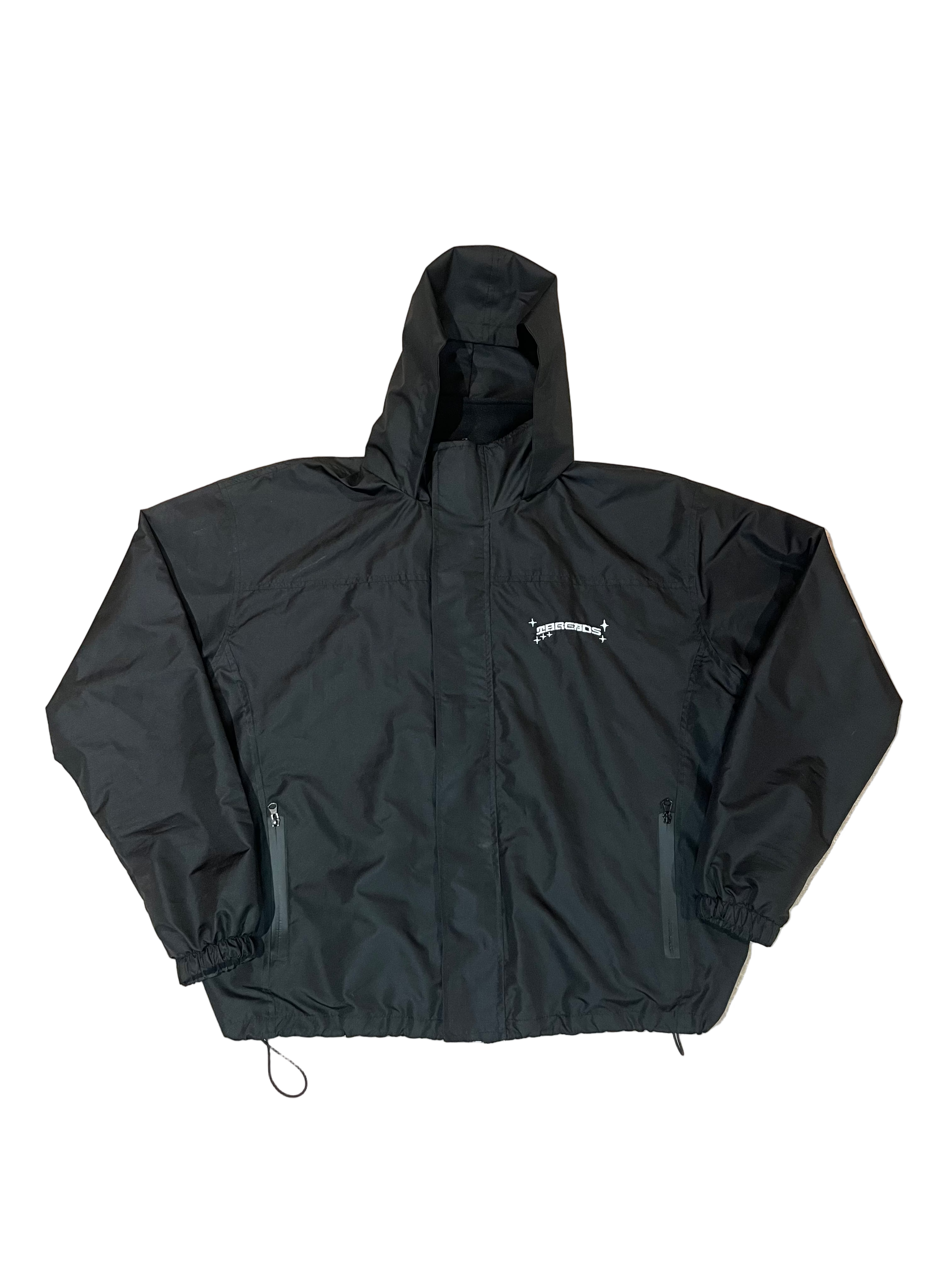 Black jacket with a brand logo on a beige carpet